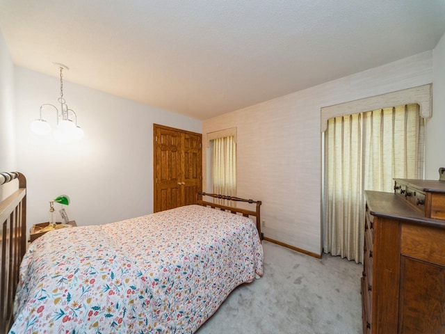 bedroom with light carpet and baseboards