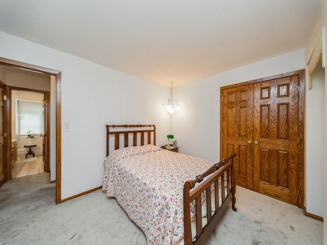 bedroom with light colored carpet and baseboards