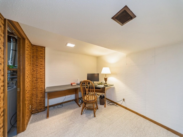 carpeted office featuring washer / clothes dryer and baseboards