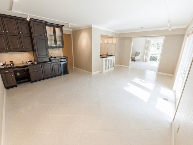 kitchen featuring dark countertops, ornamental molding, dark brown cabinetry, baseboards, and track lighting