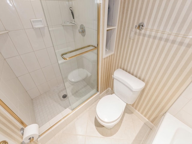 full bath with toilet, wallpapered walls, a shower stall, and tile patterned floors