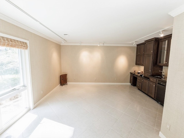 unfurnished living room with rail lighting, ornamental molding, light tile patterned floors, and baseboards