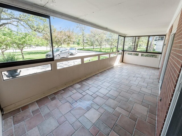 unfurnished sunroom featuring plenty of natural light