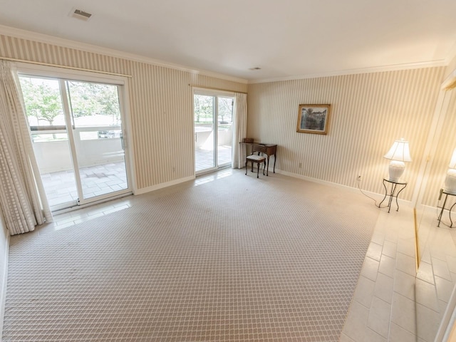 spare room with crown molding and baseboards