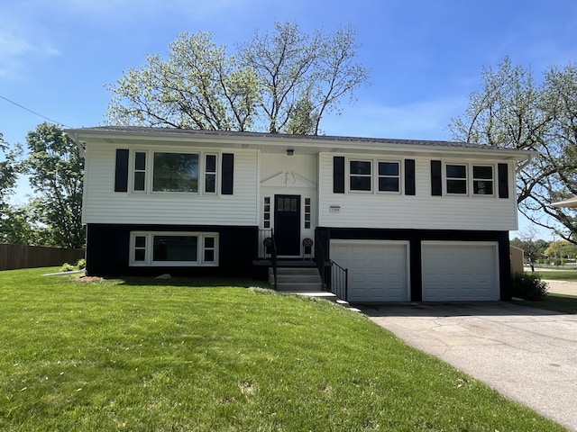 raised ranch featuring an attached garage and concrete driveway