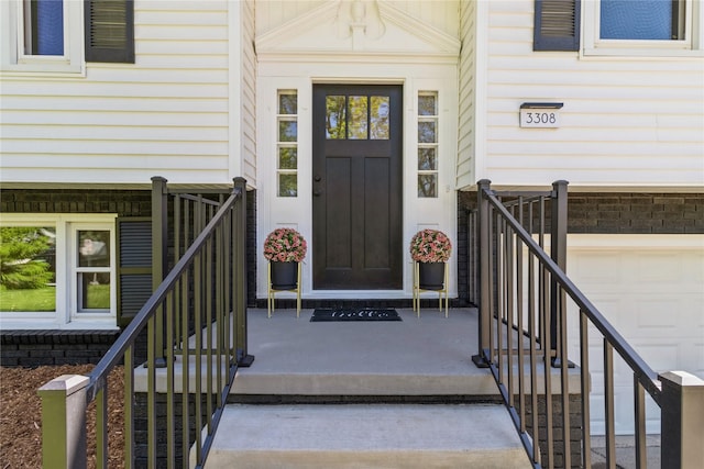 view of exterior entry featuring an attached garage