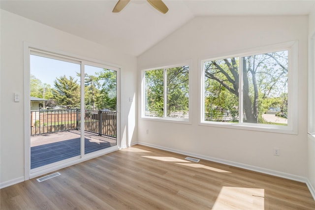 unfurnished sunroom featuring vaulted ceiling