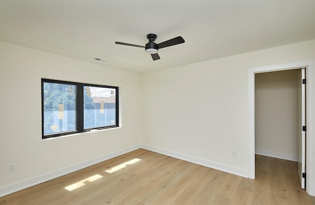 4727 Hillsdale Dr, Urbandale, IA 50322 - spare room with light wood finished floors, a ceiling fan, and baseboards