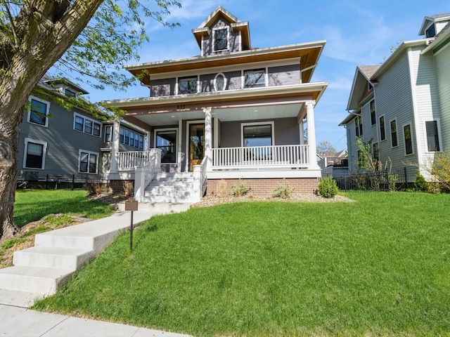 traditional style home featuring covered porch and a front lawn