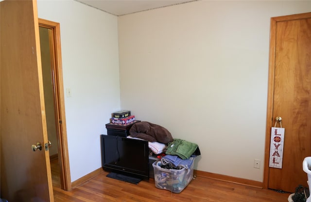 misc room with wood finished floors and baseboards