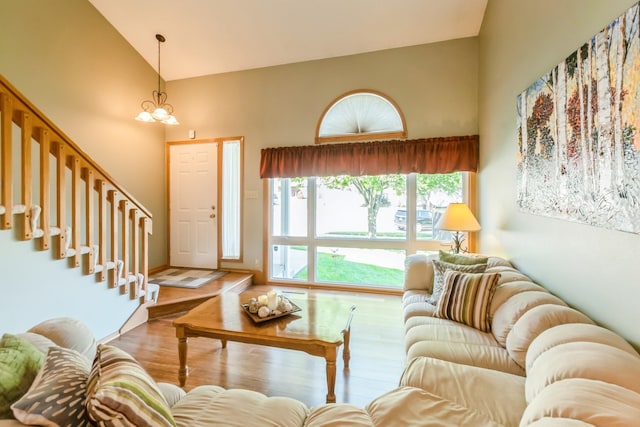 1249 NW 108th Cir, Clive, IA 50325 - living area featuring high vaulted ceiling, wood finished floors, a chandelier, and stairway