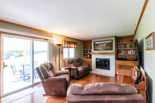 1249 NW 108th Cir, Clive, IA 50325 - living room with a textured ceiling, a tiled fireplace, and wood finished floors