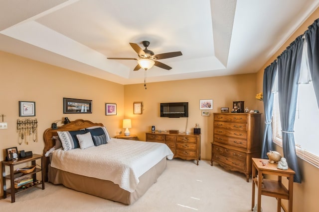 1249 NW 108th Cir, Clive, IA 50325 - bedroom featuring a raised ceiling, light colored carpet, and a ceiling fan