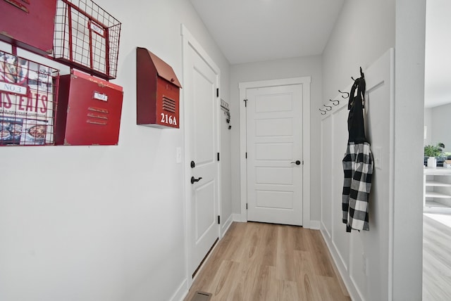 entryway featuring wood finished floors and baseboards