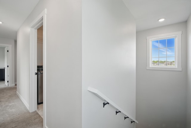 hall featuring light colored carpet, an upstairs landing, baseboards, and recessed lighting