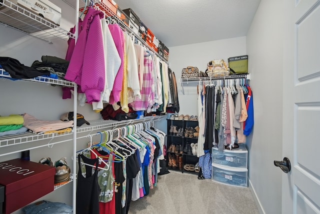 walk in closet featuring carpet