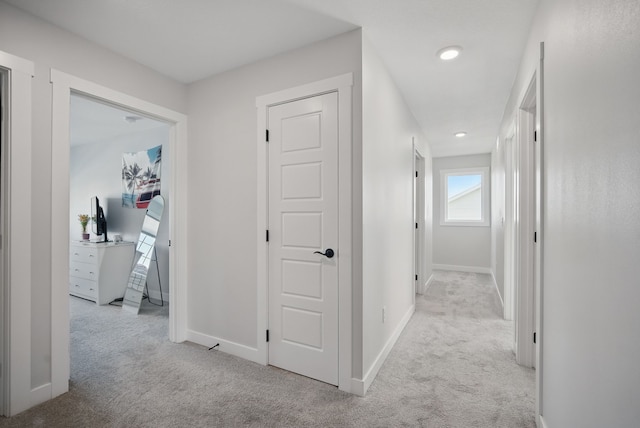 hall featuring carpet floors, baseboards, and recessed lighting