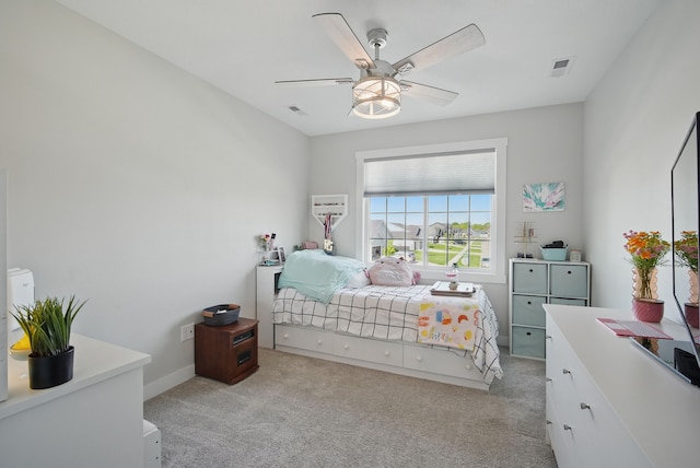 bedroom with light colored carpet and a ceiling fan