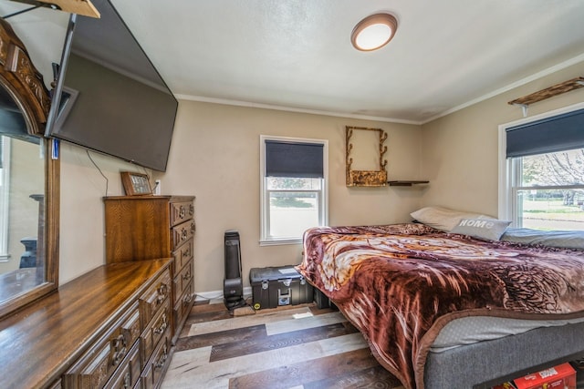 1523 Allison Ave, Des Moines, IA 50314 - bedroom with wood finished floors, crown molding, and baseboards