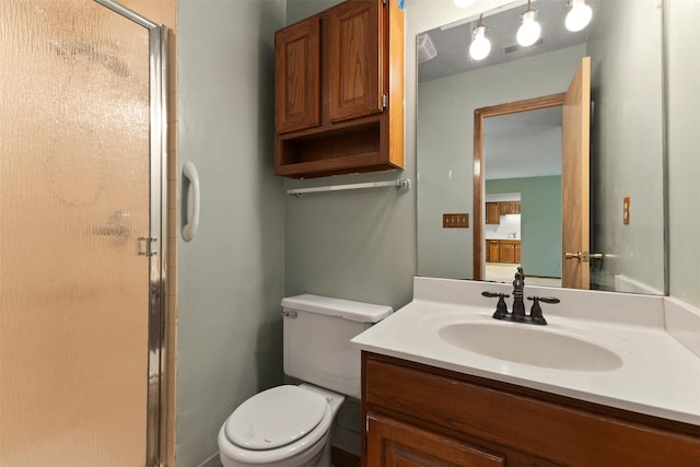 full bathroom featuring a shower stall, vanity, and toilet