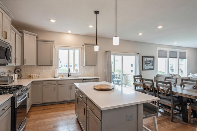2920 Oak St, Norwalk, IA 50211 - kitchen with gray cabinets, a sink, appliances with stainless steel finishes, plenty of natural light, and recessed lighting