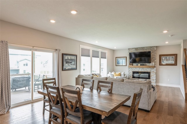 2920 Oak St, Norwalk, IA 50211 - dining space featuring hardwood / wood-style flooring, a fireplace, recessed lighting, and baseboards
