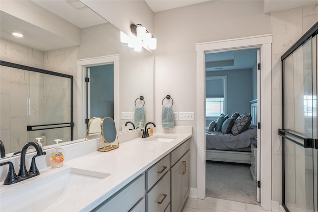 2920 Oak St, Norwalk, IA 50211 - ensuite bathroom featuring marble look tiles, double vanity, and a shower stall