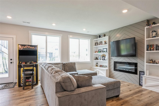 2920 Oak St, Norwalk, IA 50211 - living area with light wood finished floors, a large fireplace, and recessed lighting