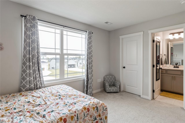2920 Oak St, Norwalk, IA 50211 - bedroom with light carpet, baseboards, and ensuite bathroom