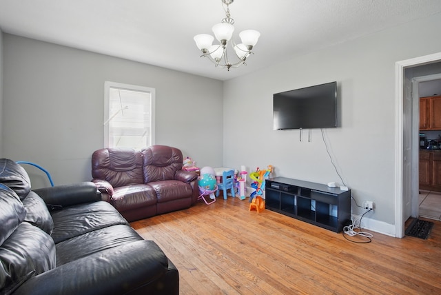 2057 Maple St, Des Moines, IA 50317 - living area with a chandelier and wood finished floors
