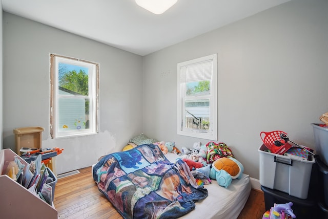 2057 Maple St, Des Moines, IA 50317 - bedroom featuring multiple windows and hardwood / wood-style floors