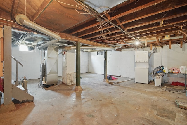 2057 Maple St, Des Moines, IA 50317 - below grade area with heating unit and stacked washer / dryer