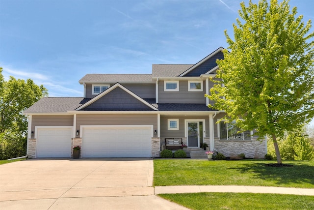 4782 SE 34th Ct, Des Moines, IA 50320 - craftsman-style house with an attached garage, a front yard, driveway, stone siding, and a shingled roof