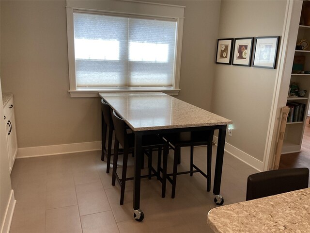 dining room with baseboards and tile patterned floors