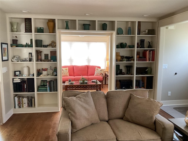sitting room with dark wood finished floors and baseboards