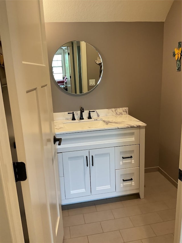 bathroom featuring tile patterned floors, vanity, and baseboards