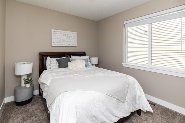 carpeted bedroom featuring baseboards