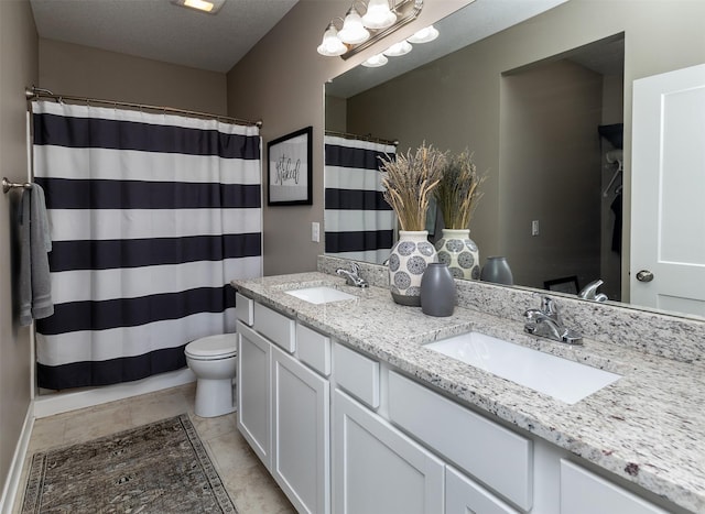 bathroom featuring toilet, double vanity, and a shower with shower curtain