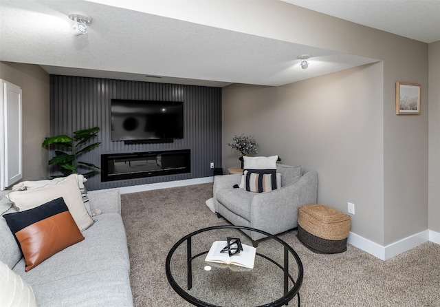 carpeted living room with baseboards and a glass covered fireplace