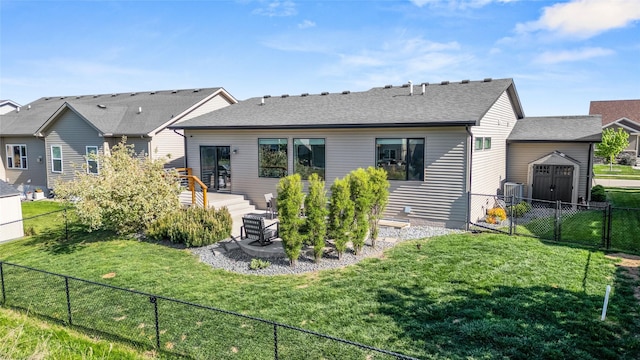 rear view of house featuring a shed, a shingled roof, an outdoor structure, and cooling unit