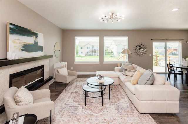 501 SE 15th St, Grimes, IA 50111 - living area with wood finished floors, a chandelier, a glass covered fireplace, and recessed lighting