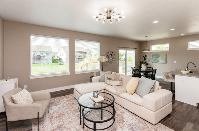 501 SE 15th St, Grimes, IA 50111 - living room with dark wood-type flooring, plenty of natural light, a chandelier, and recessed lighting