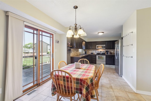 4727 80th Pl, Urbandale, IA 50322 - dining area featuring a chandelier and light tile patterned floors