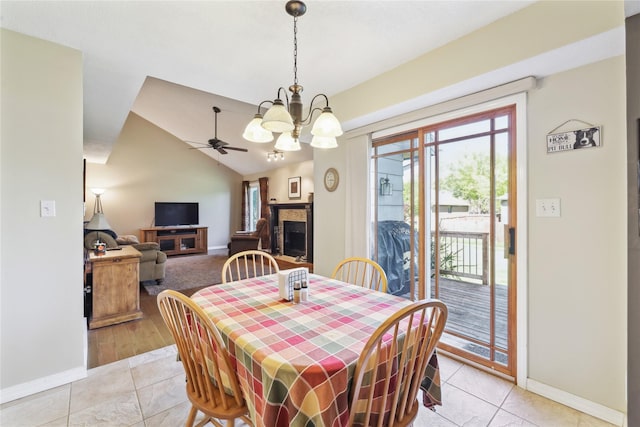 4727 80th Pl, Urbandale, IA 50322 - dining room featuring a chandelier, a ceiling fan, light tile patterned floors, a fireplace, and lofted ceiling