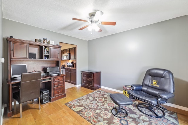 4727 80th Pl, Urbandale, IA 50322 - office space featuring ceiling fan, light wood-style flooring, and a textured ceiling