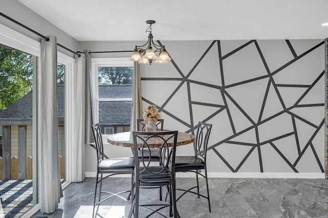 518 Maxwelton Dr, Des Moines, IA 50315 - dining room featuring a chandelier, baseboards, and marble finish flooring
