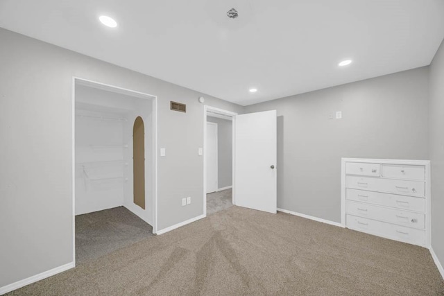518 Maxwelton Dr, Des Moines, IA 50315 - unfurnished bedroom featuring carpet floors, recessed lighting, a walk in closet, arched walkways, and baseboards