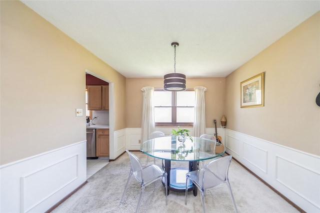 4021 80th St, Urbandale, IA 50322 - dining area featuring a wainscoted wall, light colored carpet, and a decorative wall
