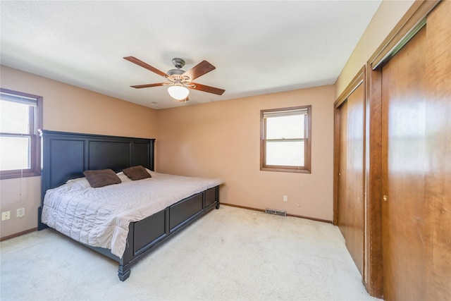 4021 80th St, Urbandale, IA 50322 - bedroom featuring light carpet, a closet, baseboards, and a ceiling fan