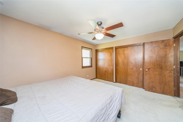 4021 80th St, Urbandale, IA 50322 - carpeted bedroom with two closets and a ceiling fan